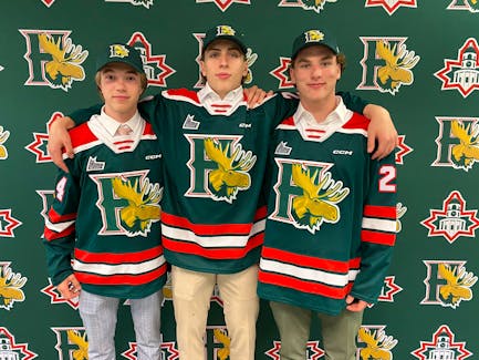 Danny Walters, centre, is joined by fellow Halifax McDonald's players Logan Trewin, left, and Gavin Sudds after being drafted by the Halifax Mooseheads in Moncton on the weekend. - Halifax Mooseheads