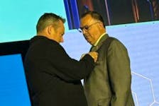 Deputy Mayor Stewart being presented with the President’s Pin by now Past President Scott Pearce at the FCM Conference. Contributed