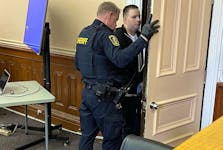 A sheriff's officer escorts Jonathon Hurley back to the lockup from Newfoundland and Labrador Supreme Court in St. John's Monday, June 10, after the adjournment of his trial for the day.