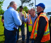 Staff-Sgt. Joe Farrell, left, listens as Frank Campbell points his finger and yells at him about the proposed by-law which will regulate tow truck companies during Wednesday's protest. NICOLE SULLIVAN/CAPE BRETON POST