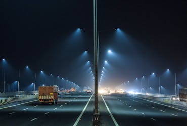 Traffic moves along a highway amidst haze and smog in New Delhi, India, November 18, 2022. 