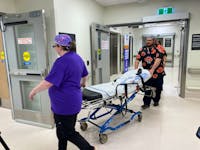 Members of the patient transfer team bring an empty stretcher back down to the patient transfer area after getting a patient situated in their room at the new Western Memorial Regional Hospital in Corner Brook on Sunday, June 2, 2024. - Diane Crocker/SaltWire