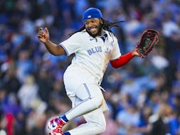 Vladimir Guerrero Jr. leaps off third base as the Blue Jays celebrate their 5-4 win over the Pittsburgh Pirates at the Rogers Centre on June 2, 2024.