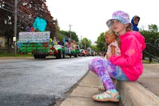 Bridgetown’s Sawyer Trim, who is 7.5 years old, watches the Annapolis Valley Apple Blossom Festival’s grand street parade make its way to Kentville Memorial Park on June 1.