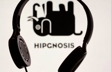 A headset is seen in front of displayed Hipgnosis logo in this illustration taken, June 28, 2021.