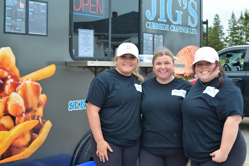 Jig's Curbside Cravings owner Lisa Martin, centre, with her daughters Keira Rose, left, and Hailey Rose outside the food truck on opening day May 28. The family decided to open the small business to help with university costs for both Keira and Hailey. NICOLE SULLIVAN / CAPE BRETON POST