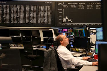 A stock broker works at Frankfurt's stock exchange as markets react on the coronavirus disease (COVID-19), at the stock exchange in Frankfurt, Germany, March 27, 2020.