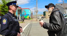 Cape Breton Regional Police Const. James Fitzgerald, who is assigned to downtown Sydney, chats with Clifford Morrison by the Ally Centre. BARB SWEET/CAPE BRETON POST