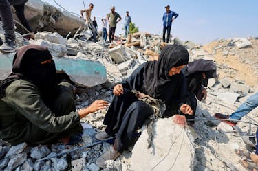 Palestinian sisters Samar and Sahar react as they search for their missing mother Amira Al-Breim at the rubble of a house hit in an Israeli strike, in Khan Younis in the southern Gaza Strip, June 3, 2024.