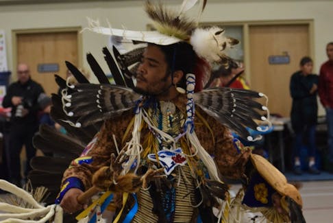 Male head dancer Bronson Acquin-Mandisodza from St Mary's, Mi'kma'ki dressed in intricate regalia while dancing Sunday afternoon. - Sarah Jordan