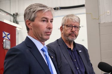 John Lohr, right, the minister responsible for the Emergency Management Office, listens to Premier Tim Houston during an Emergency Services Provider Fund announcement in September in Canning.