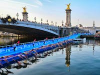 Triathlon athletes start to compete swimming in the Seine river next to the Alexandre III bridge during a Test Event for the women's triathlon for the upcoming 2024 Olympic Games.