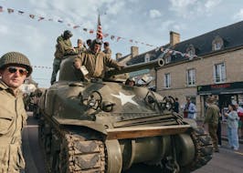 
          A tank used in the U.S. landing at Normandy on June 6, 1944, rolls into Ste.-Mere-Eglise, France, as part of a parade of military vehicles, June 3, 2024. Some aging residents of Ste.-Mère-Église in Normandy can still recall the American paratroopers who dropped into their backyard. It's been a love affair ever since. (Andrea Mantovani/The New York Times)
        