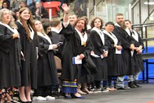 Felicia Paul of Membertou, fourth from left, waves at the people who've supported her through her NSCC studies. Paul cried when speaker Graham Marshall spoke about her father (his cousin) the late Danny Paul. NICOLE SULLIVAN/CAPE BRETON POST