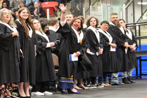 Felicia Paul of Membertou, fourth from left, waves at the people who've supported her through her NSCC studies. Paul cried when speaker Graham Marshall spoke about her father (his cousin) the late Danny Paul. NICOLE SULLIVAN/CAPE BRETON POST