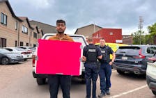 Organizer Rupinder Pal Singh holds a sign that reads, "King, do the right thing" on June 7. He said he and other protesters were told they could come into the P.E.I. office of immigration in Charlottetown to discuss their options to remain in Canada with officials. Although police were called to the building that day, as of early afternoon, none of the protestors had been detained. Vivian Ulinwa • SaltWire