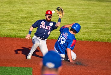 Chris Farrow of the Sydney Sooners, left, prepares to catch the ball and tag the runner attempting to steal second base during Nova Scotia Senior Baseball League action at the Susan McEachern Memorial Ball Park in Sydney on Friday. The runner was called safe on the play. Sydney won its home-opener 3-1 over the Nova Scotia Selects under-17 team. JEREMY FRASER/CAPE BRETON POST.
