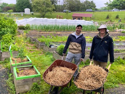 Nick Smith, left, and Matthew Goodz enjoy a drizzly Saturday volunteering at the Common Roots Urban Farm BiHi in Halifax.