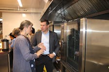 Wolfville Farmers’ Market executive director Kelly Marie Redcliffe explains the many advantages of a new commercial kitchen to Kings-Hants MP Kody Blois June 29.  
Jason Malloy