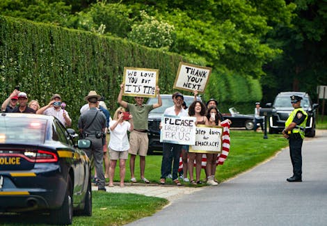 
          People hold signs calling for President Joe Biden to step aside this upcoming election in East Hampton, N.Y., as Biden's motorcade passes by on Saturday, June 29, 2024. The Biden campaign had hoped Thursday's debate would force voters to sooner accept the reality of a Trump-Biden rematch. (Haiyun Jiang/The New York Times)
        