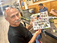 Wedgeport Legion Branch president Curtis Doucet holds up the flies he tied during the Heroes Mending on the Fly Canada program, which took place every Sunday evening for months at the Legion hall. TINA COMEAU