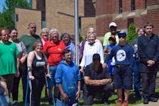 Members of the town of Truro, and People First Nova Scotia, Truro Chapter, gathered at Truro town hall to celebrate the beginning of disability pride month with the raising of the disability pride flag.