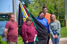 From left to right Tim Ferris, Cathy Langille, Crystal MacLean, Charles McConville, Emma Proudfoot standing at Glasgow Square ready to raise the disability pride flag for the month of July.