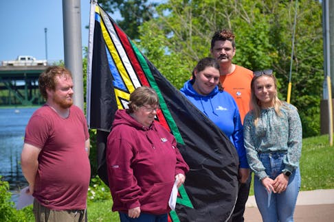 From left to right Tim Ferris, Cathy Langille, Crystal MacLean, Charles McConville, Emma Proudfoot standing at Glasgow Square ready to raise the disability pride flag for the month of July.