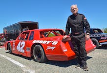 Willard MacKay stands near his red No. 42 car in the pit area at Bud’s Speedway in Sydney on June 16. At age 72, MacKay returned to the track for the first time last month after 28 years away from the sport. CONTRIBUTED/KEN MACISAAC