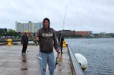 It was a wet Saturday in Cape Breton but that didn't stop Billy Holm and a group of anglers from trying their hand off the south berth of the Port of Sydney. Holm, from South Bar, snagged this mackerel with his first catch of the afternoon. Not everybody was able to get their fun in though on Saturday - the weather forced the cancellation and postponement of community festivals and fun days in Port Hawkesbury, Membertou and Glace Bay. LUKE DYMENT/CAPE BRETON POST
