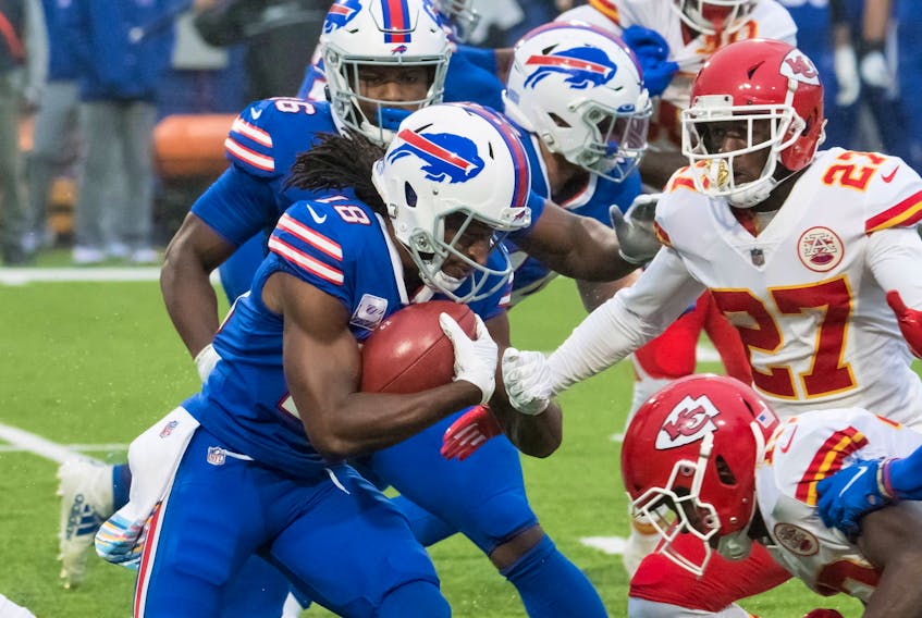 Buffalo Bills wide receiver Andre Roberts prepares to be tackled by Kansas City Chiefs' Byron Pringle (13) and cornerback Rashad Fenton on Monday night.