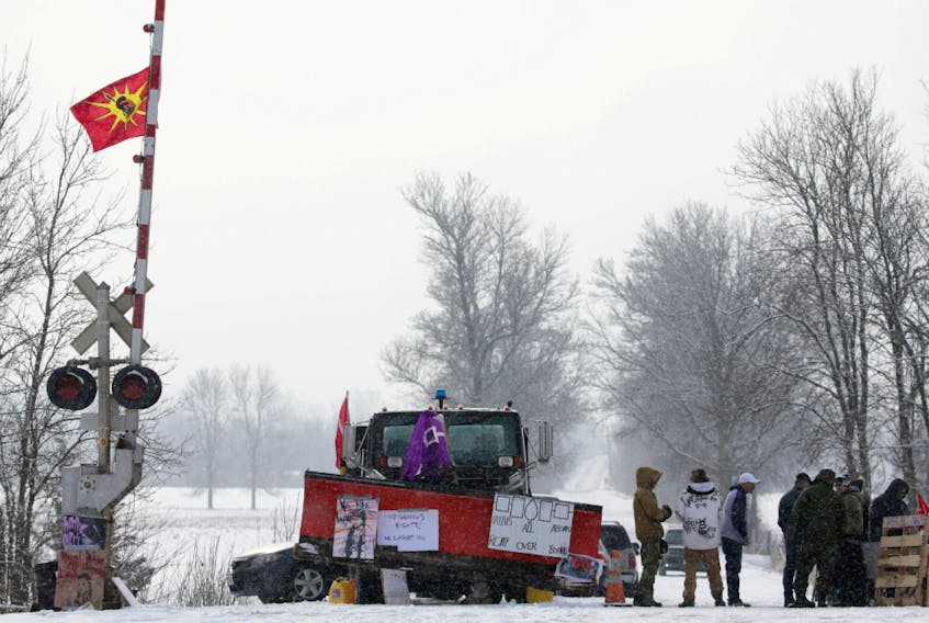 First Nations members of the Tyendinaga Mohawk Territory block train tracks servicing Via Rail, as part of a protest against British Columbia's Coastal GasLink pipeline, in Tyendinaga, Ontario, Canada February 13, 2020.  