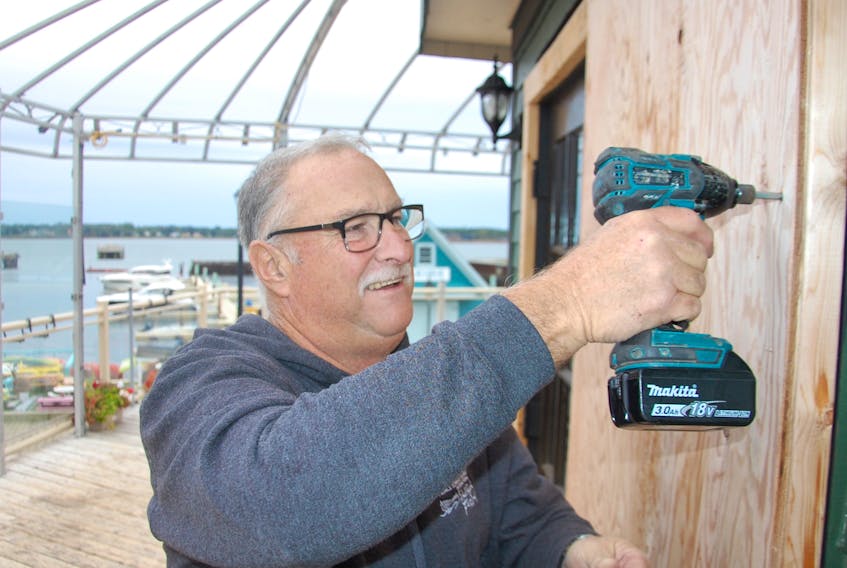 Roger Murphy boards up the windows and doors at Peake's Quay Restaurant and Bar in Charlottetown for the season. The boarding is done at the end of each season but it was done early this year to protect the building as hurricane Teddy is forecasted to hit P.E.I. as a post-tropical storm.