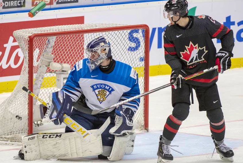 Team Canada forward Dylan Cozens watches the puck get past Finland goalie Justus Annunen during Saturday's world junior semifinal game in Ostrave, Czech Republic. (POSTMEDIA)