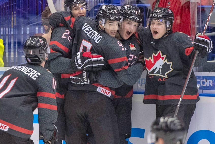 Canada's Dylan Cozens (22, back left) celebrates with teammates (left to right) Alexis Lafreniere, Joe Veleno, Barrett Hayton and Calen Addison after scoring the first goal against Russia during second period action in the gold medal game at the World Junior Hockey Championships, Sunday, Jan. 5, 2020 in Ostrava, Czech Republic. 
