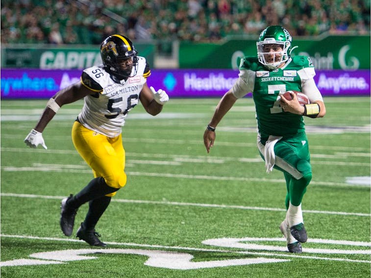 Cody Fajardo, right, rushed for a game-high 56 yards while quarterbacking the Saskatchewan Roughriders to a 24-19 victory over the visiting Hamilton Tiger-Cats on Thursday.