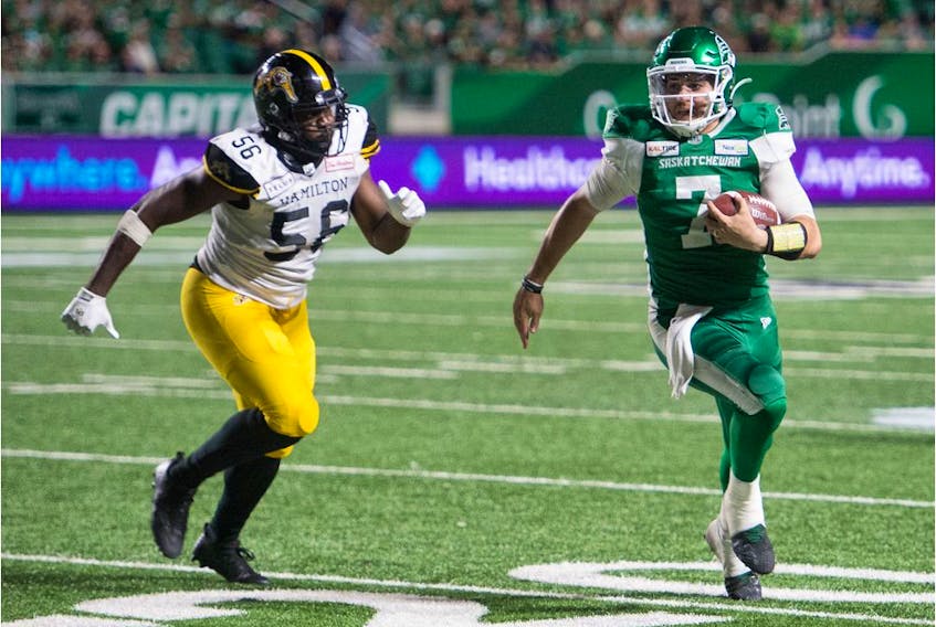 Cody Fajardo, right, rushed for a game-high 56 yards while quarterbacking the Saskatchewan Roughriders to a 24-19 victory over the visiting Hamilton Tiger-Cats on Thursday.