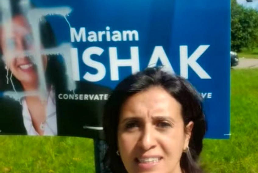 Mariam Ishak, the Conservative candidate in Pierrefonds-Dollard, stands in front of one of her campaign signs that had been defaced with a swastika, in a screengrab from a video she posted on Facebook Sept. 16, 2019. Credit: Facebook