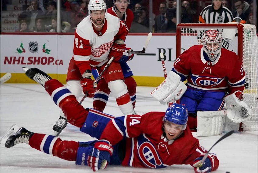  Canadiens’ Nick Suzuki tips the puck away as he falls to the ice as goaltender Carey Price follows the play in Montreal on Saturday, Dec. 14, 2019.