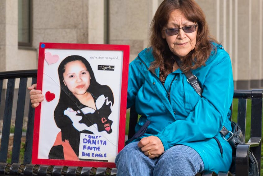 REGINA, SASK : September 18, 2020  -- Dianne BigEagle holds a photo of her daughter Danita in front of Court of Queen's Bench in Regina, Saskatchewan on Sept. 18. 2020. Danita has been missing since 2007. BRANDON HARDER/ Regina Leader-Post