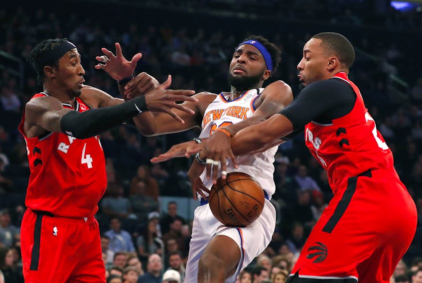New York Knicks centre Mitchell Robinson (middle) battles Toronto Raptors forward Rondae Hollis-Jefferson (left) and guard Norman Powell  for a rebound during Friday's game. (USA TODAY SPORTS)