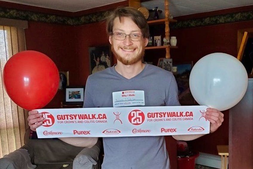 Logan MacLean holds a sign for the 25th annual Gutsy Walk. MacLean was diagnosed with Crohn's disease when he was in Grade 6, but this is the first year he's been healthy enough to participate in the walk.