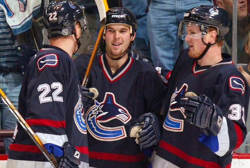 Jason King, centre, who once drew notice as a winger for the Sedin twins leading to the trio being dubbed the Mattress Line has been promoted from the Utica Comets to serve as an assistant coach to Canucks head coach Travis Green. In this photo, Daniel Sedin, left, and brother Henrik congratulate King after he scored a goal against the Minnesota Wild on Nov. 8, 2003 in Vancouver.