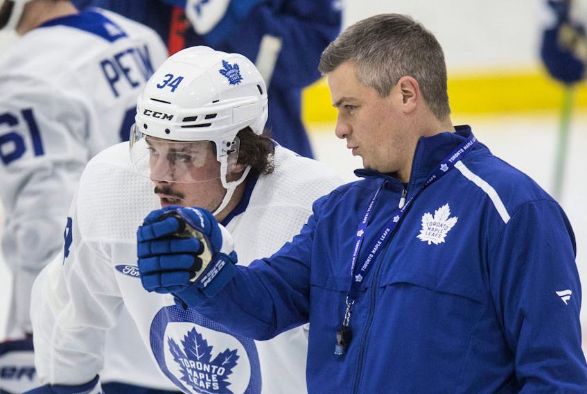  Coach Sheldon Keefe (right) and Auston Matthews talk at Toronto Maple Leafs practice earlier this season.