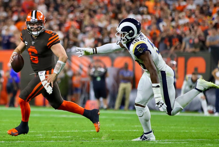 Cleveland Browns quarterback Baker Mayfield runs from a Rams defender last week. (GETTY IMAGES)