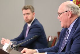 Nova Scotia Premier Iain Rankin looks on as Chief Medical Officer Robert Strang answers questions from the media during a Covid-19 briefing Tuesday.