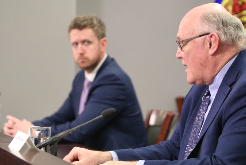 Nova Scotia Premier Iain Rankin looks on as Chief Medical Officer Robert Strang answers questions from the media during a Covid-19 briefing Tuesday.