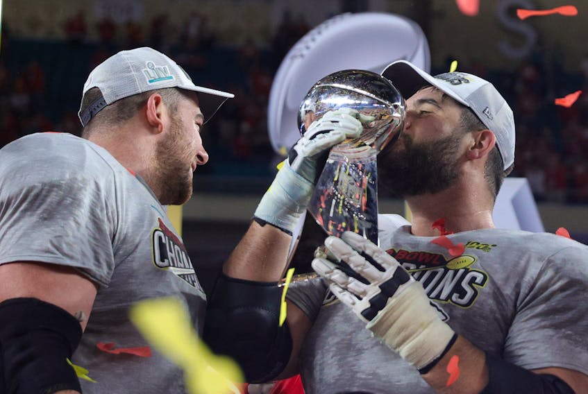 Laurent Duvernay-Tardif (right) of the Kansas City Chiefs celebrates with the Vince Lombardi Trophy after defeating the San Francisco 49ers in Super Bowl LIV this year.