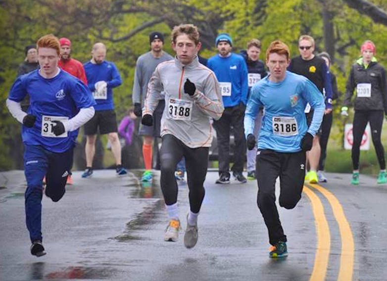 The three eventual top finishers in Sunday's Athletics North East open one-mile race head down the Boulevard. Evan Knight (left) finished first, with Levi Moulton (centre) in second place and Eric Knight (Evan's twin brother) was third. — NLAA/Facebook
