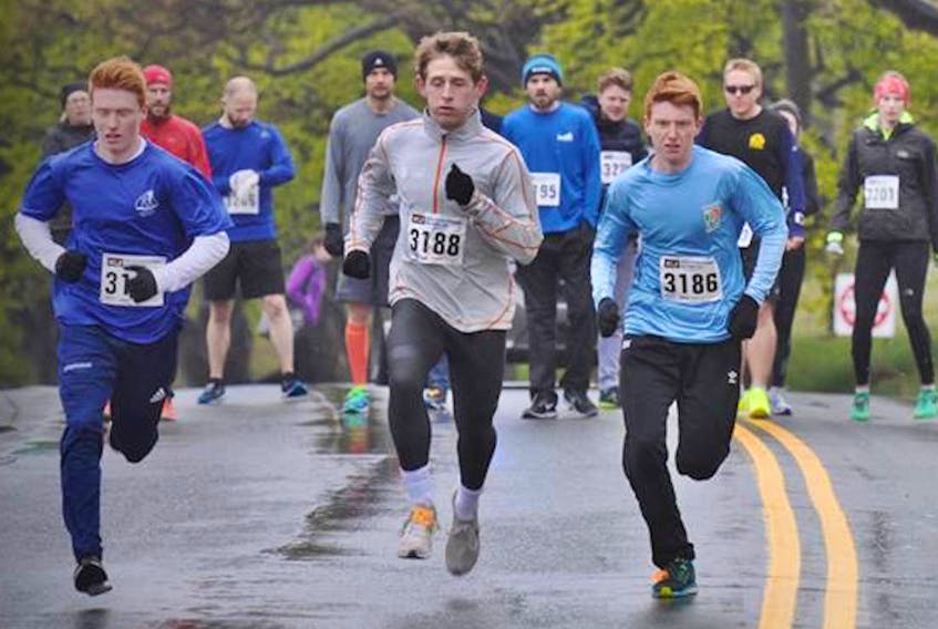 The three eventual top finishers in Sunday's Athletics North East open one-mile race head down the Boulevard. Evan Knight (left) finished first, with Levi Moulton (centre) in second place and Eric Knight (Evan's twin brother) was third. — NLAA/Facebook